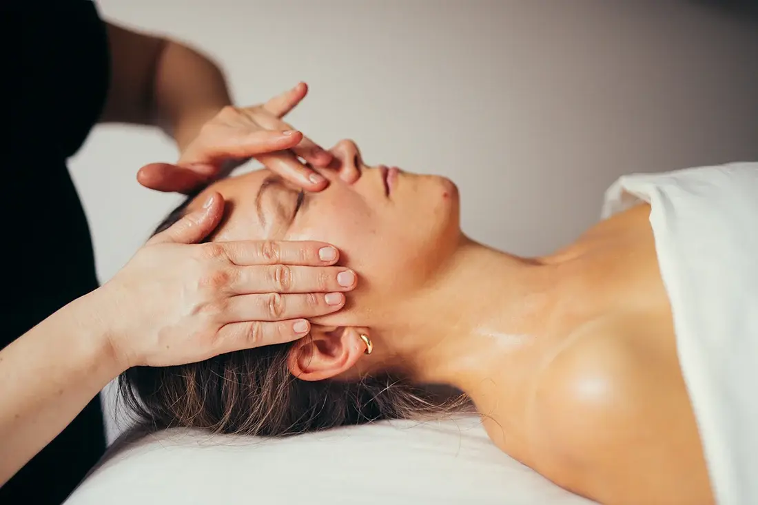 Hands-on massage of the face and jaw area