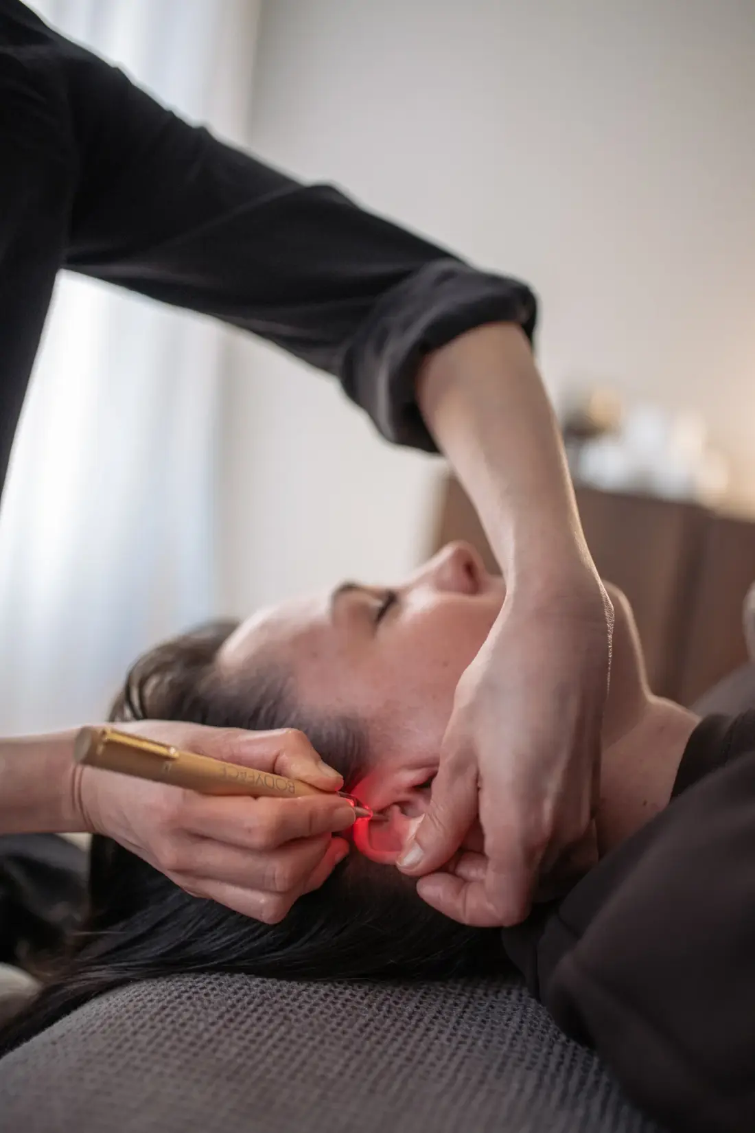 Ear treatment while supporting the client's head at manualtherapies, Frederiksberg.