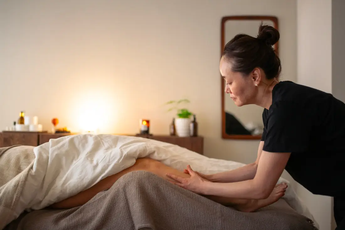 Ayako massaging a client's forearm at manualtherapies, Frederiksberg.